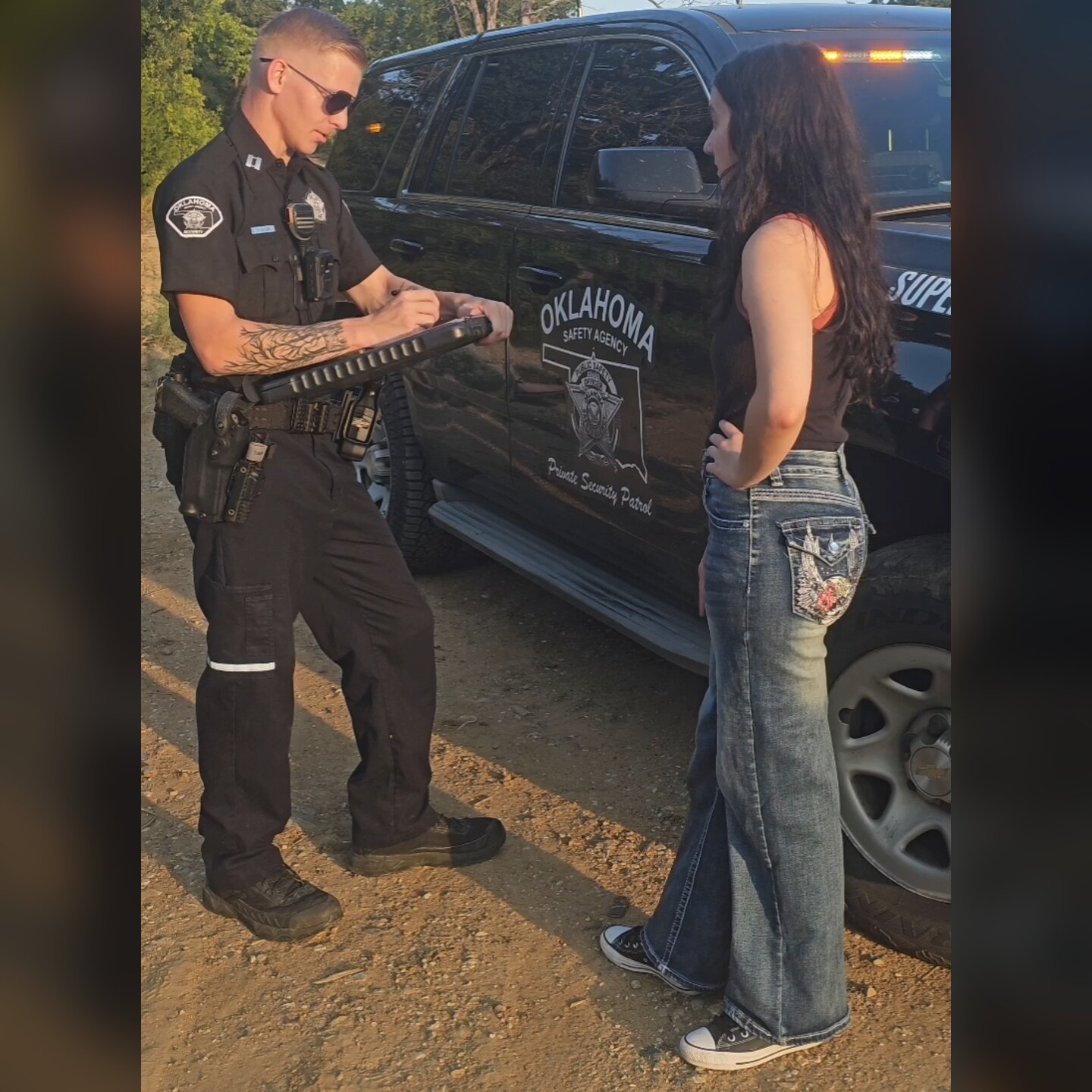 Oklahoma Safety Agency officer assisting a motorist beside a marked patrol SUV