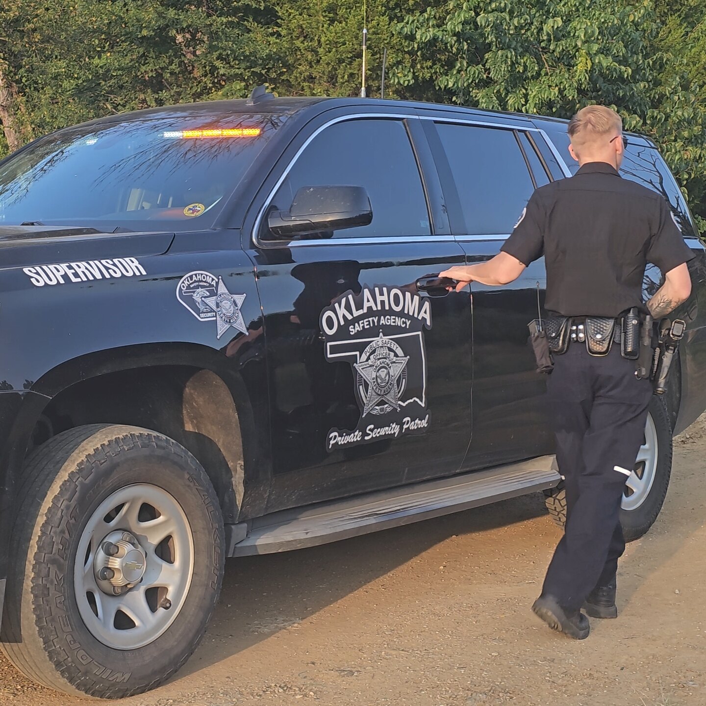 Oklahoma Safety Agency supervisor at the door of a marked patrol SUV